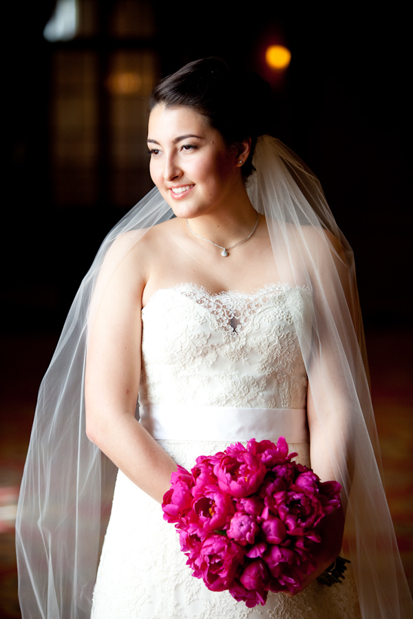 beautiful bride in white embellished gown with full-length veil holding bouquet of dark pink peonies - photo by Seattle based wedding photographers La Vie Photography